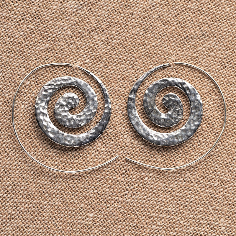 Handmade nickel free solid silver, flat, dimpled textured spiral hoop earrings designed by OMishka.