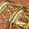 An adjustable and extra wide, pure brass, open circle patterned cuff bracelet designed by OMishka.
