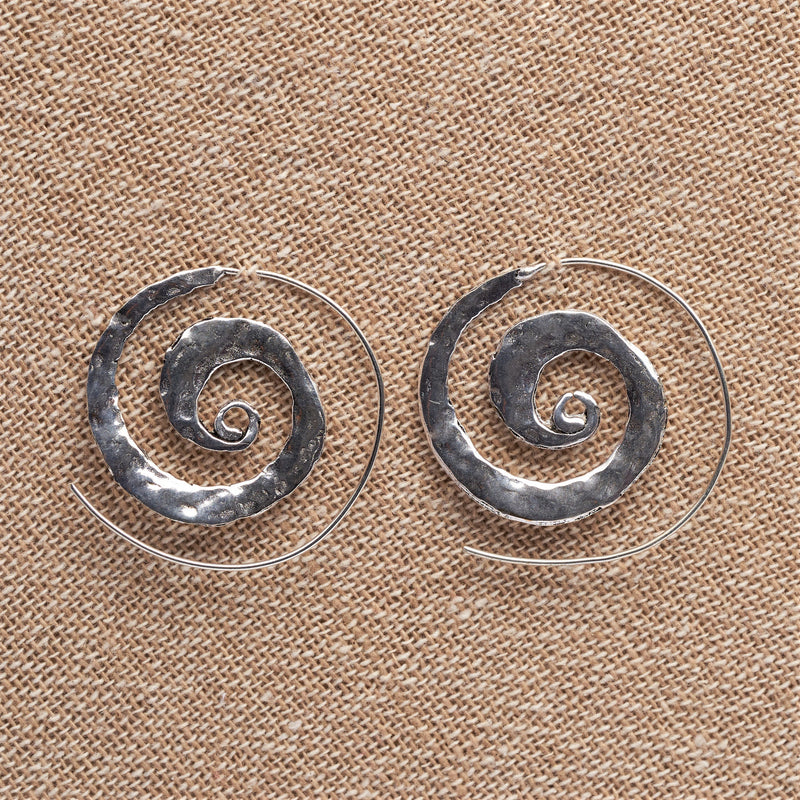 Handmade nickel free solid silver, flat, hammered textured spiral hoop earrings designed by OMishka.