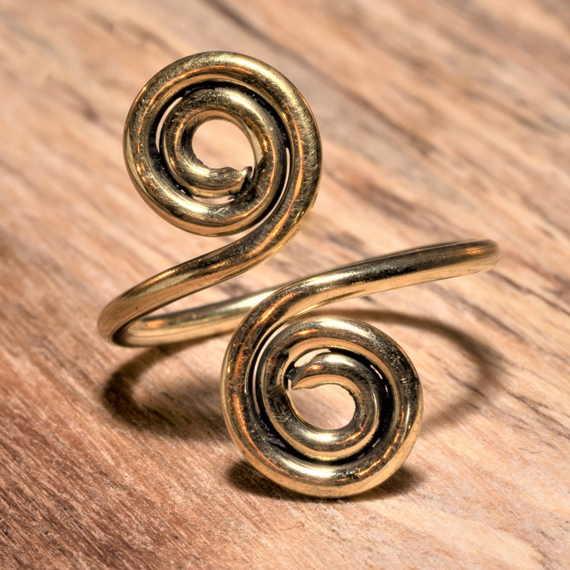 An adjustable, handmade pure brass, double spiral open wrap ring designed by OMishka.