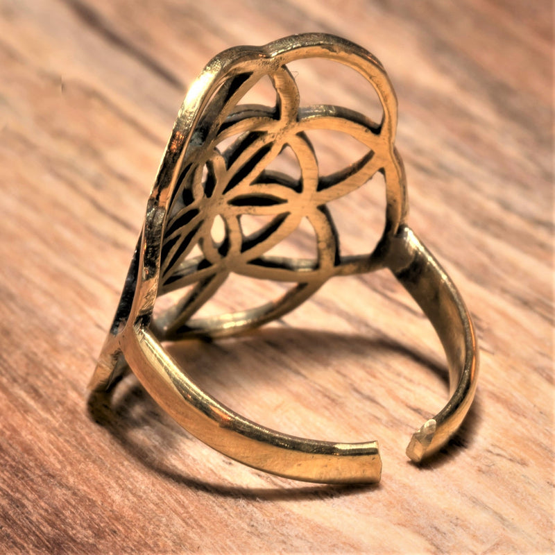An adjustable, handmade pure brass seed of life ring designed by OMishka.