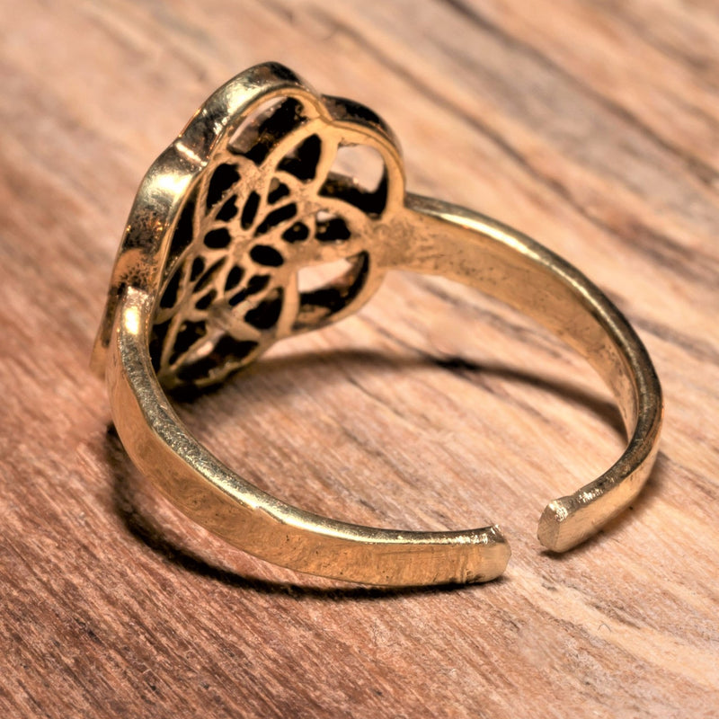 An adjustable, dainty, handmade pure brass seed of life ring designed by OMishka.