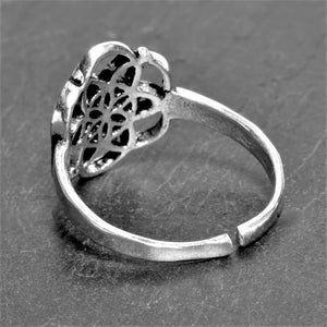 An adjustable, dainty, handmade solid silver seed of life ring designed by OMishka.