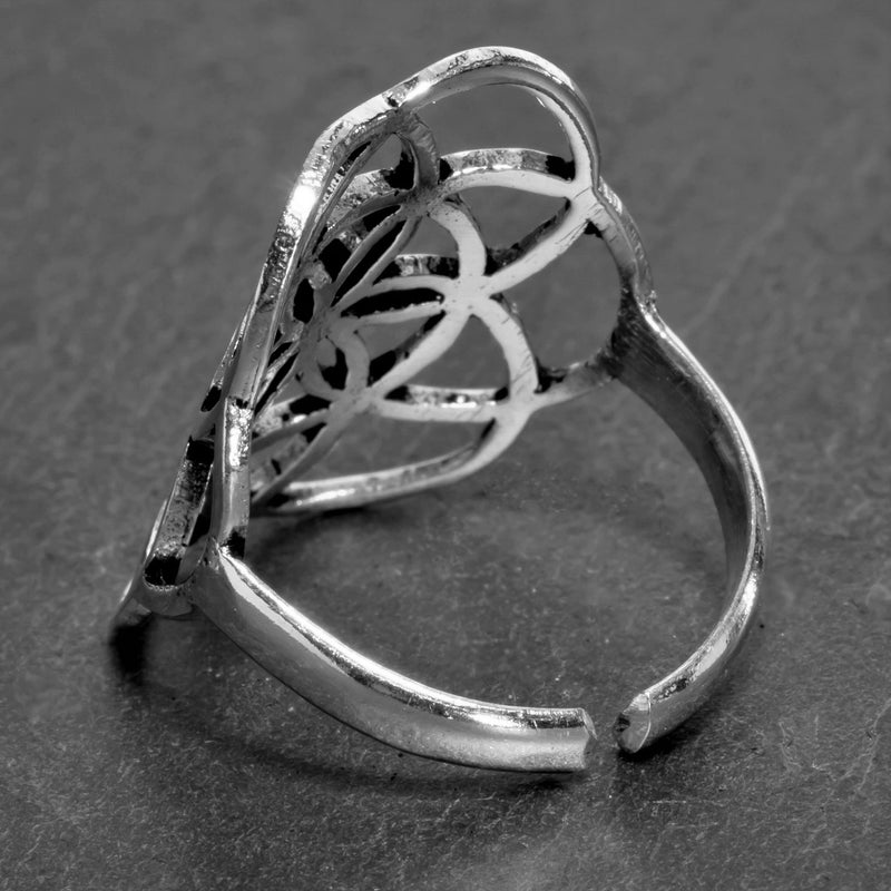 A handmade, adjustable, solid silver seed of life ring designed by OMishka.