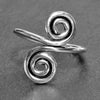 An adjustable, handmade solid silver, double spiral wrap ring designed by OMishka.