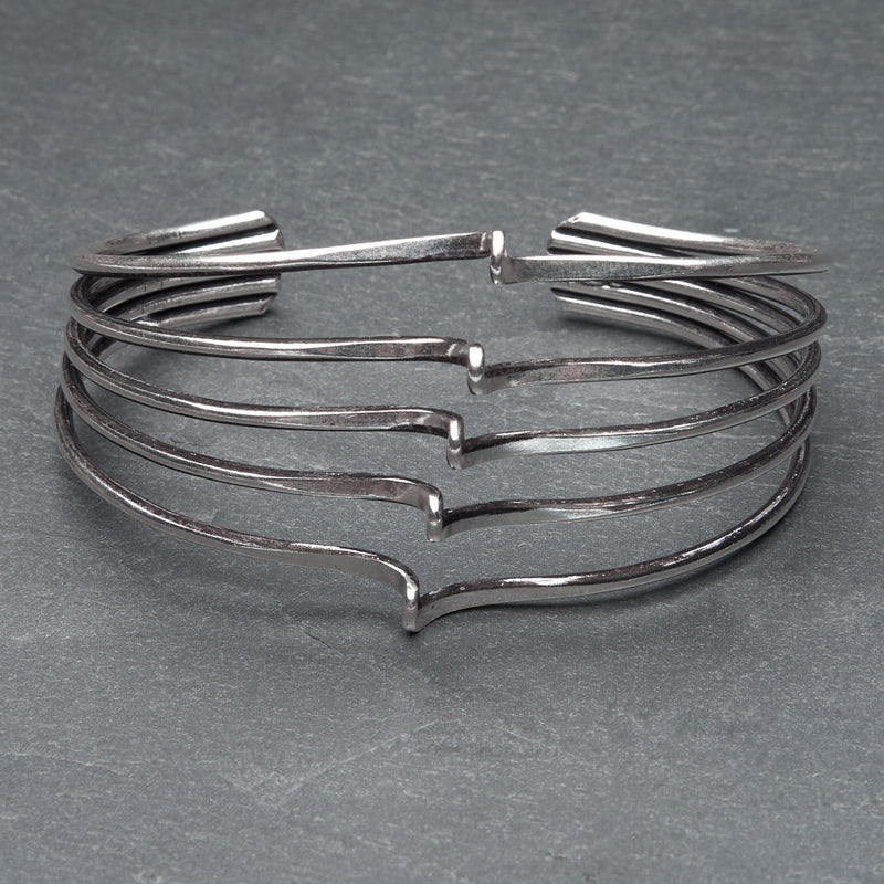 A handmade adjustable silver, multi wave open cuff bracelet designed by OMishka.