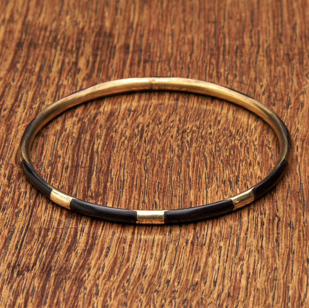A handmade, pure brass and black enamel striped thin bangle bracelet designed by OMishka.