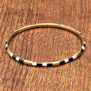 A handmade, pure brass, black and white enamel striped thin bangle bracelet designed by OMishka.