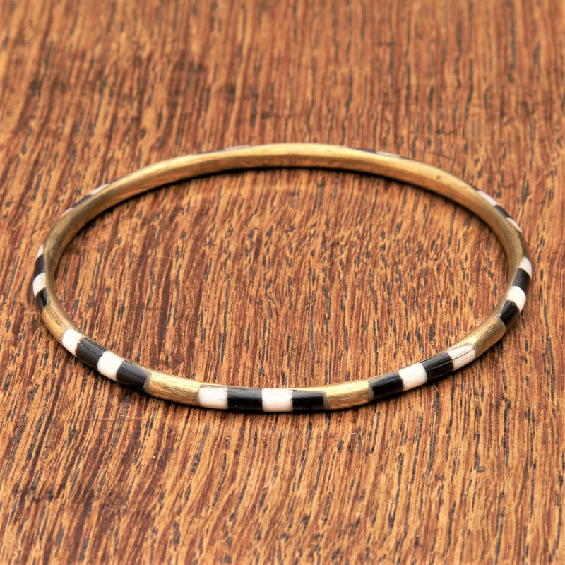 A handmade, pure brass, black and white enamel striped thin bangle bracelet designed by OMishka.