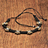 Handmade brass beaded flower, black woven macrame, dainty adjustable bracelet designed by OMishka.