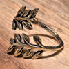 An adjustable, handmade pure brass olive branch wrap ring designed by OMishka.