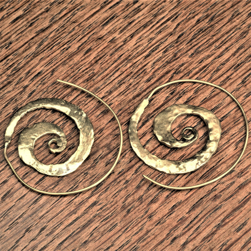 Handmade pure brass, flat, hammered textured spiral hoop earrings designed by OMishka.