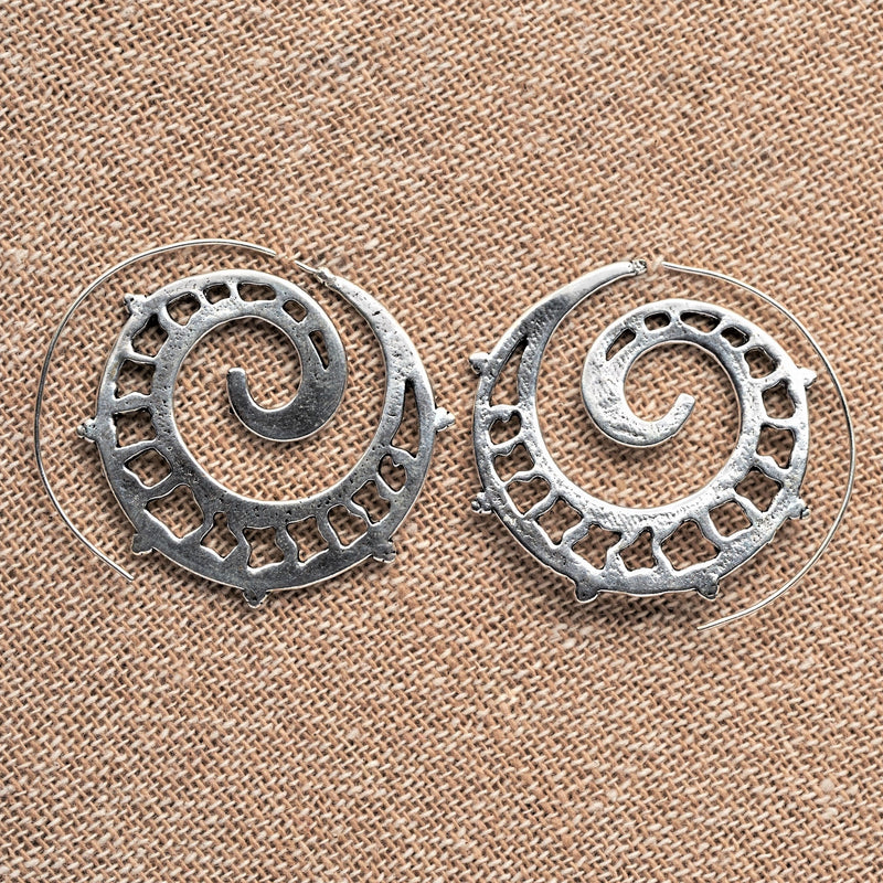 Handmade solid silver, large spiral hoop earrings with a cut out detail, designed by OMishka.