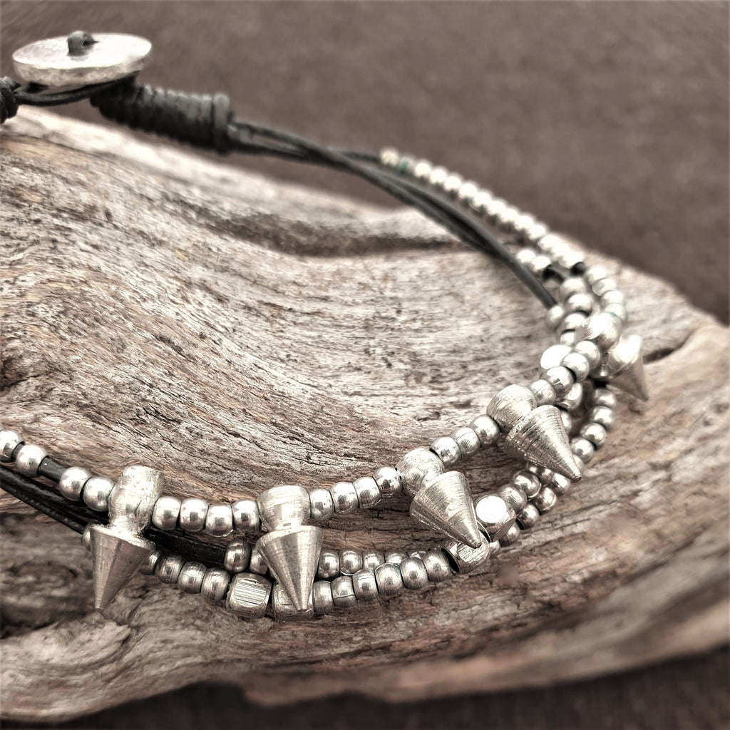 Handmade silver toned, beaded spike charm and black cord dainty bracelet designed by OMishka.