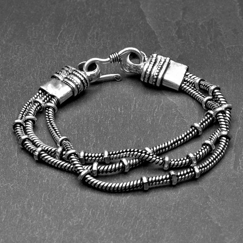 Handmade silver toned plated brass, triple strand, subtle beaded snake chain bracelet designed by OMishka.