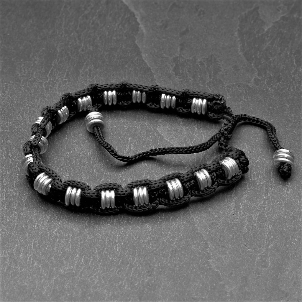 Handmade silver disc beaded, woven black hemp cord adjustable bracelet designed by OMishka.