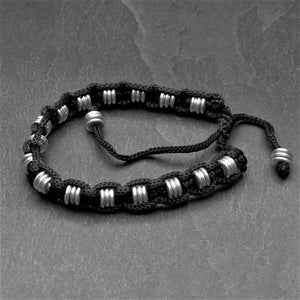 Handmade silver disc beaded, woven black hemp cord adjustable bracelet designed by OMishka.