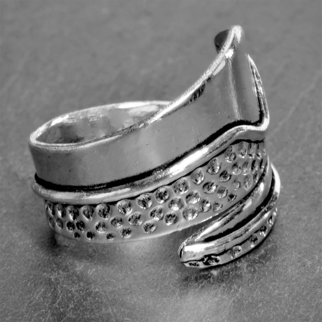 An adjustable, handmade smooth solid silver, dotted wrap ring designed by OMishka.