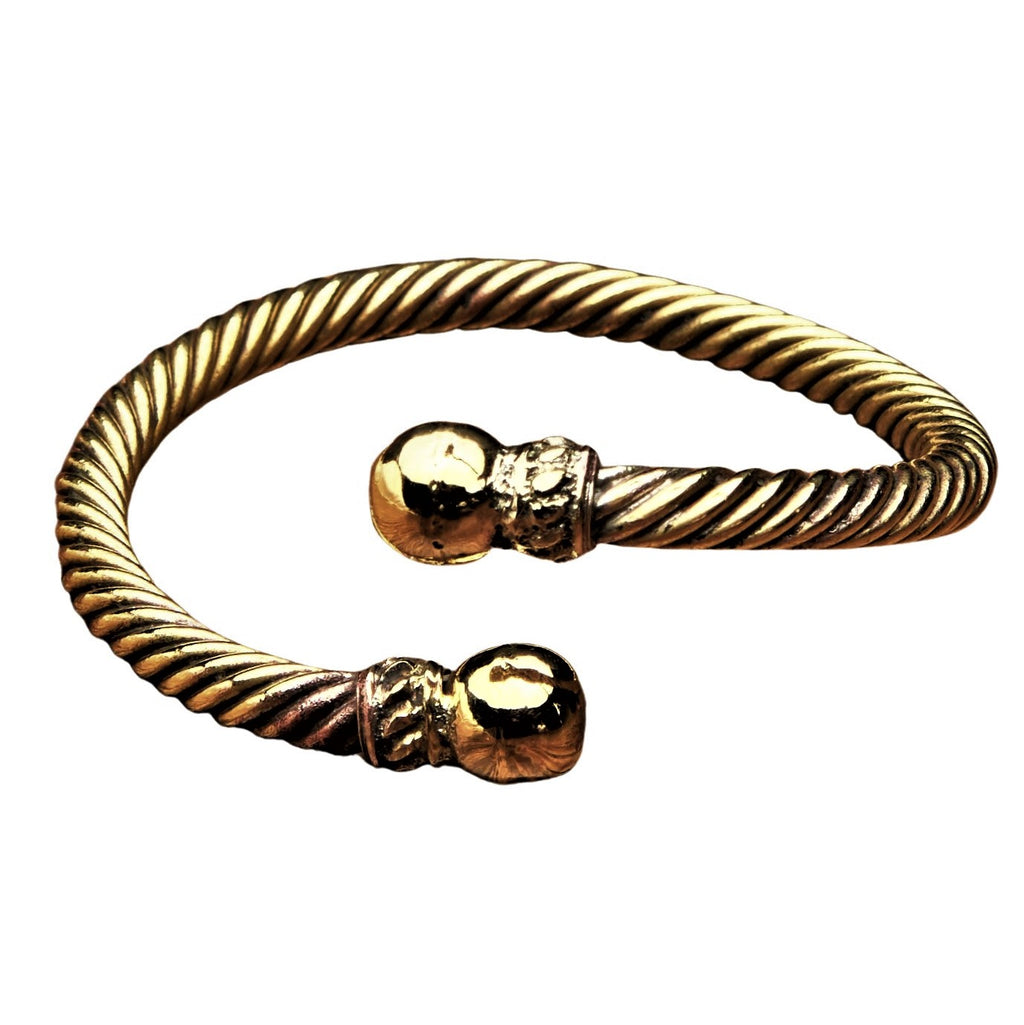 A handmade, twisted pure brass rope torque bracelet designed by OMishka.