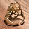 A large, handmade, adjustable pure brass seed of life ring designed by OMishka.