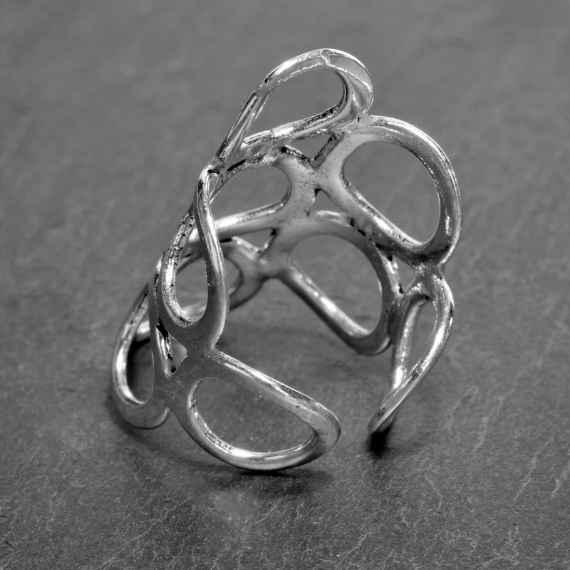 A long, adjustable, solid silver open circle wrap ring designed by OMishka.