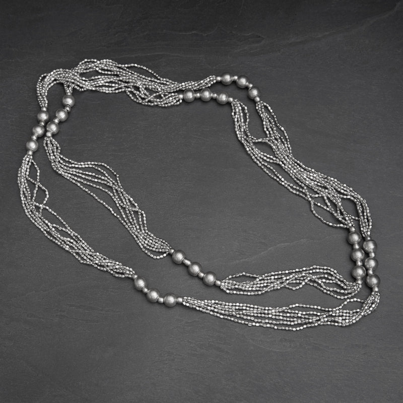Handmade and chunky, silver toned brass, long beaded multi strand necklace designed by OMishka.