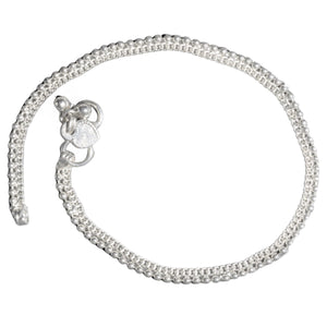 A pretty, nickel free solid silver dainty beaded anklet with tiny bells designed by OMishka.