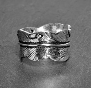 An adjustable, nickel free solid silver, feather wrap ring designed by OMishka.