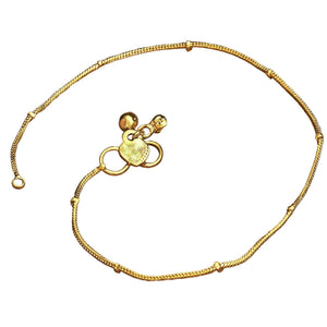 A delicate, pure brass, thin ribbed snake chain ankle bracelet with tiny bells designed by OMishka.