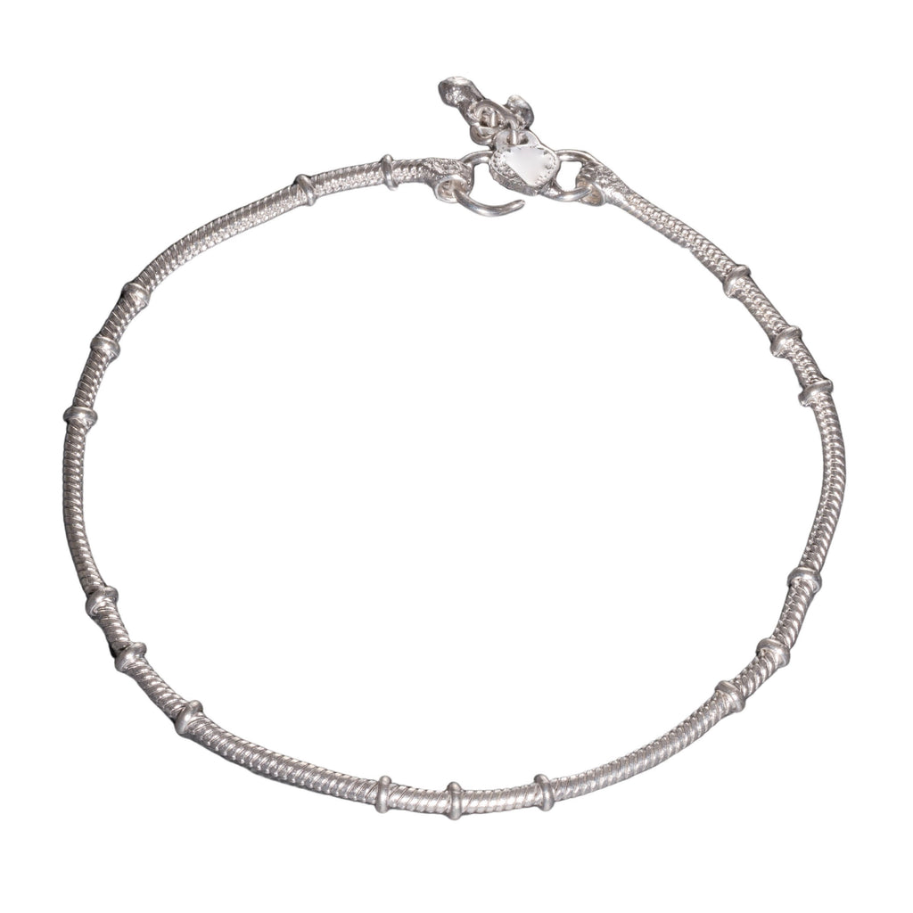 A thin, nickel free solid silver ankle chain with tiny bells designed by OMishka.
