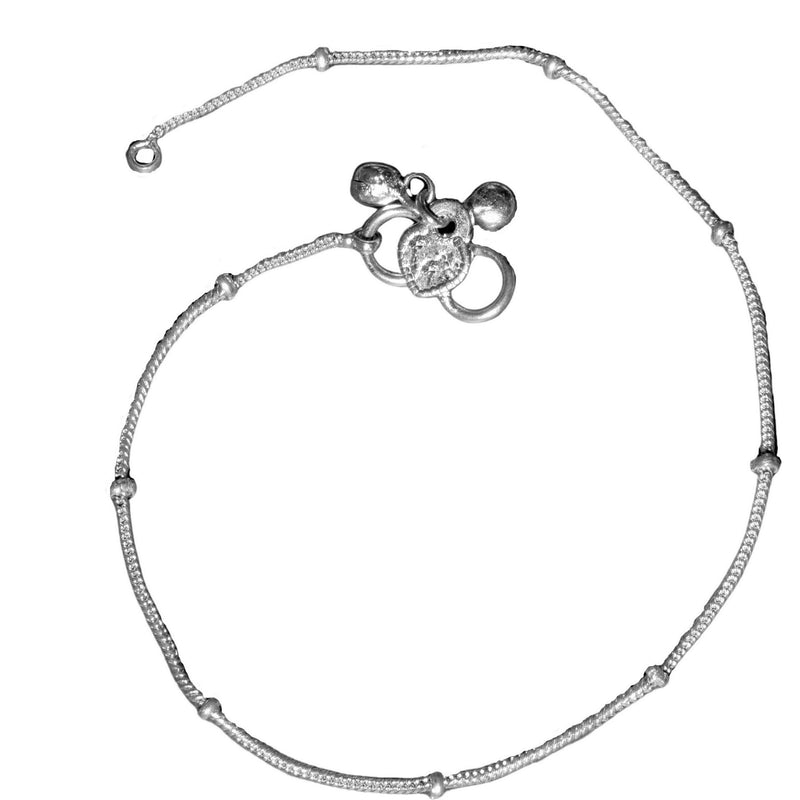 A thin, delicate solid silver snake chain ankle bracelet with tiny bells designed by OMishka.