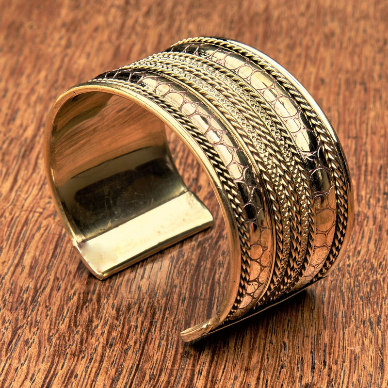 A wide, adjustable pure brass, spotty patterned and striped cuff bracelet designed by OMishka.