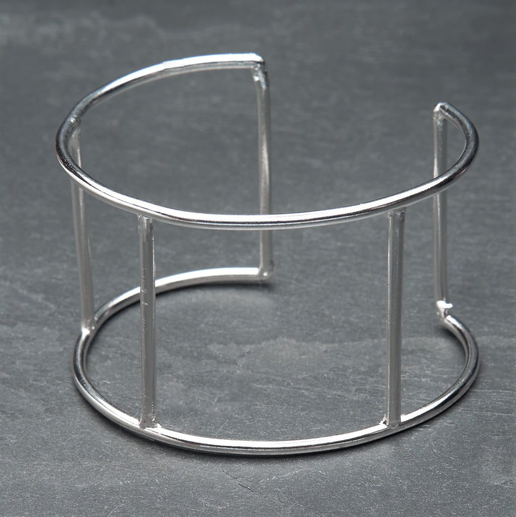 A wide, adjustable silver geometric cuff bracelet designed by OMishka.